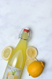 Limoncello, lemon liqueur in bottle and lemons
