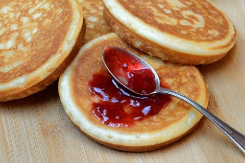 Pancake with raspberry jam and spoon