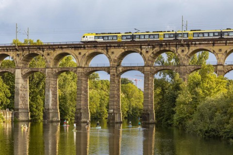 Enz viaduct Bietigheim with regional train, railway viaduct over the river Enz, stand-up paddler, Bietigheim-Bissingen, Baden-Wuerttemberg, Germany, Europe