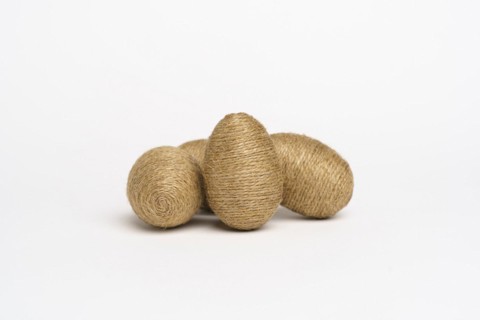 Hand wrapped easter eggs with jute twine, isolated white background. Studio