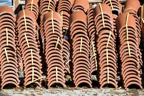 Pile of roofing tiles as a construction material at a building suppliers
