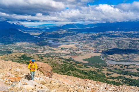 Hikers climbing to the lagoon on Cerro Castillo mountain, with the river valley of the Rio Ibanez in the background, Cerro Castillo National Park, Aysen, Patagonia, Chile, South America