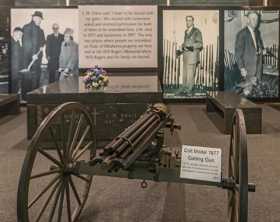 Claremore, Oklahoma, A Colt Model 1877 Gatling Gun displayed next to the tomb of J.M. Davis at the Davis Arms & Historical Museum. Davis, who collected thousands of firearms, said, I want to be buried...