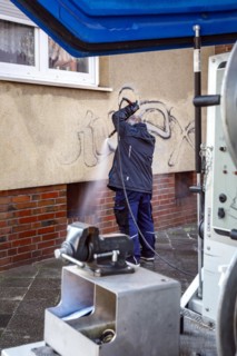 Removal of graffiti from house wall, high-pressure cleaner, residential area, Duesseldorf, North Rhine-Westphalia, Germany, Europe