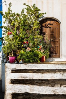 Old wooden doors with pebble mosaics on the floor, winding streets with white houses, Lindos, Rhodes, Greece, Europe