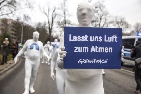 Protest of the environmental organisation Greenpeace, on the Bundesstrasse 14 40 activists demand better air quality, the Neckartor is considered the most polluted street in Germany with high levels o...