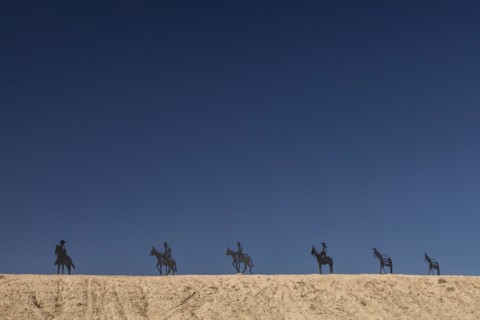 Green River, Utah, Metal sculptures of horse and burro riders at the east entrance to Green River. The sculptures are located on East Main Street near a sign welcoming visitors