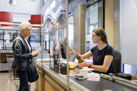 Elderly woman shopping in the supermarket. Radevormwald, Germany, Europe