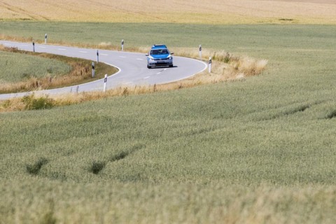 A police patrol car driving on a country road in Pfaffendo, Pfaffendorf, Germany, Europe