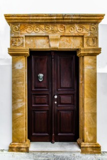 Old wooden doors with pebble mosaics on the floor, winding streets with white houses, Lindos, Rhodes, Greece, Europe