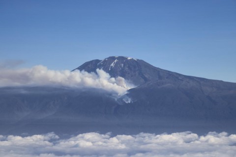 Aerial view, mountain peak of Kilimanjaro volcano with forest fire and smoke on the mountain flank, Tanzania, East Africa, Africa