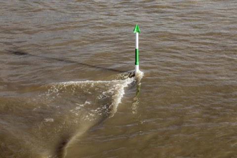 High water on the Rhine, strong current, navigation signs, navigation channel