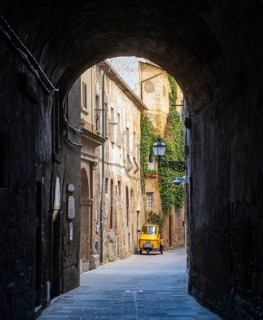 Three-wheeler in the streets of Pitigliano old town, Tuscany, Italy, Europe
