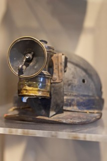 Beckley, West Virginia, A miners carbide lamp attached to his helmet on display at the mine museum at the Beckley Exhibition Coal Mine. In the lamp, calcium carbide reacts with water to produce acetyl...