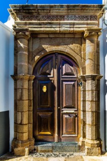 Old wooden doors with pebble mosaics on the floor, winding streets with white houses, Lindos, Rhodes, Greece, Europe