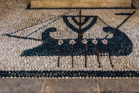 Old wooden doors with pebble mosaics on the floor, winding streets with white houses, Lindos, Rhodes, Greece, Europe