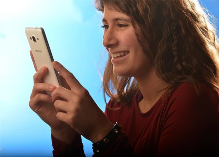 An 11-year-old girl stands as a model. With mobile phone, Germany, Europe