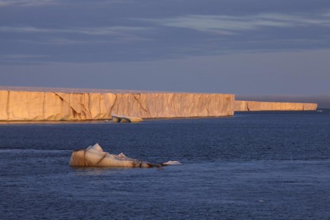 Brasvellbreen coastal glacier, glacier front in the evening light at sunset, ice chunks floating in front of it, Nordaustlandet, Svalbard