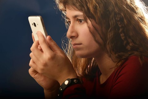 An 11-year-old girl stands as a model. With mobile phone, Germany, Europe