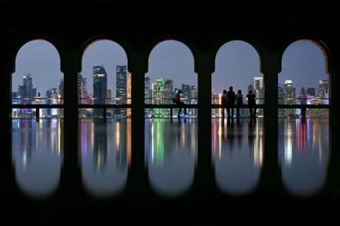 View of the illuminated skyline of Doha, Qatar, from the terrace of the Museum of Islamic Art by the archtics Ieoh Ming Pei and Jean-Michel Wilmotte, Asia