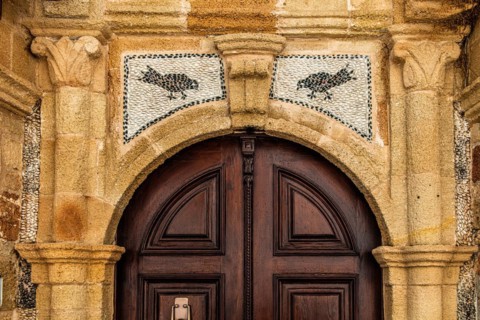 Old wooden doors with pebble mosaics on the floor, winding streets with white houses, Lindos, Rhodes, Greece, Europe