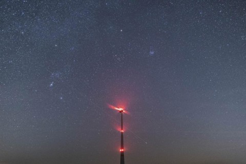 An illuminated wind turbine stands out against the starry sky in Vierkirchen, 14.02.2023., Vierkirchen, Germany, Europe