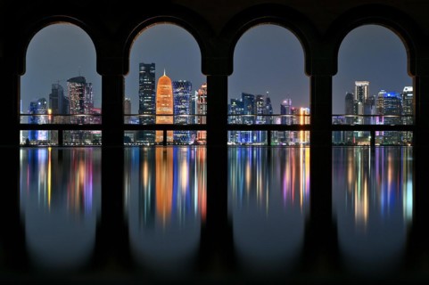 View of the illuminated skyline of Doha, Qatar, from the terrace of the Museum of Islamic Art by the archtics Ieoh Ming Pei and Jean-Michel Wilmotte, Asia
