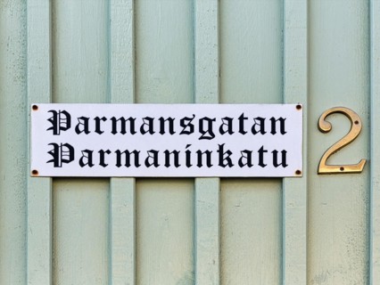 Bilingual street sign on wooden facade, wooden house, street name Parmansgatan in Swedish and Finnish, house number 2, Old Town of Kristinestad, Kristiinankaupunki, Oesterbotten, Finland, Europe