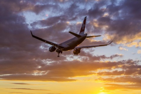 ZRH Airport with aircraft on approach of the airline Swiss, Bombardier BD-500, sunset, Zurich, Switzerland, Europe