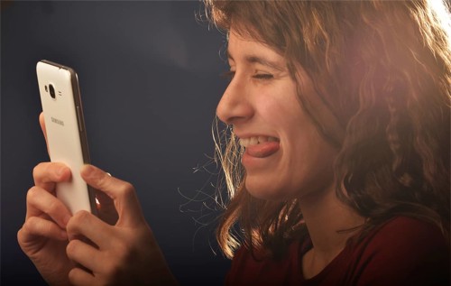 An 11-year-old girl stands as a model. With mobile phone, Germany, Europe