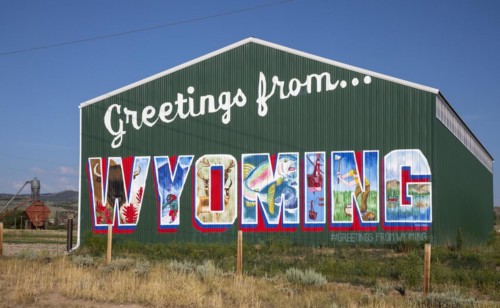 Encampment, Wyoming, A barn painted as a postcard-style greeting from Wyoming