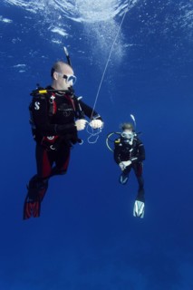 Diver, female diver, exercise, setting the safety buoy, 5th rope hold and checking diving depth with dive computer, Red Sea, Hurghada, Egypt, Africa