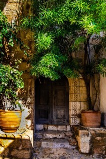 Old wooden doors with pebble mosaics on the floor, winding streets with white houses, Lindos, Rhodes, Greece, Europe