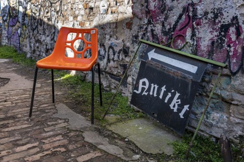 Plastic chair in orange, RAW site, former Reichsbahn repair works, Friedrichshain, Berlin, Germany, Europe