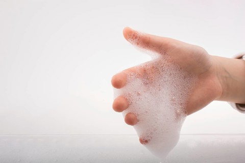 Hand washing and soap foam on a foamy background