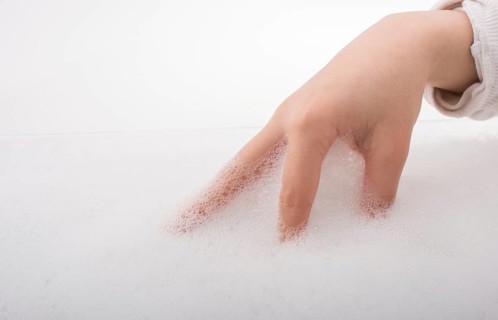 Hand washing and soap foam on a foamy background
