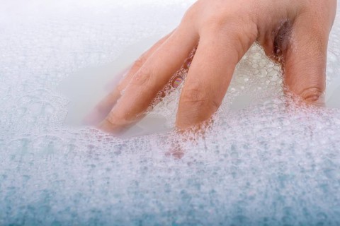 Hand washing and soap foam on a foamy background