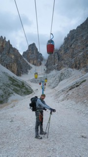 Tourist from the inventory trail in the gully with the gondola lift to Forcella Staunies