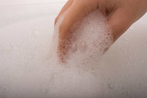 Hand washing and soap foam on a foamy background