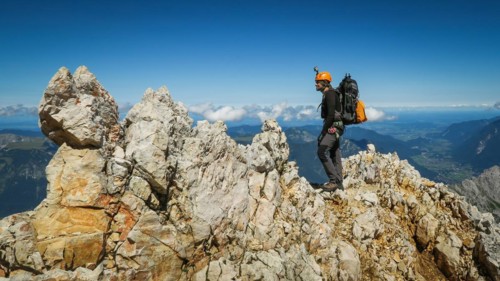 Tourist with equipment on the via ferrata trail in the alps. Zugspitze massif