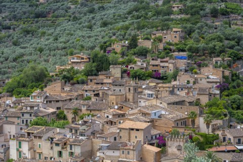 View of typical houses of the mountain village Fornalutx with church Parroquia catolica La Natividad de la virgen Maria