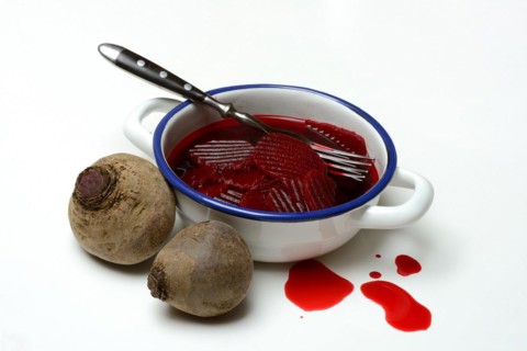 Sliced pickled beetroot with peel and fork