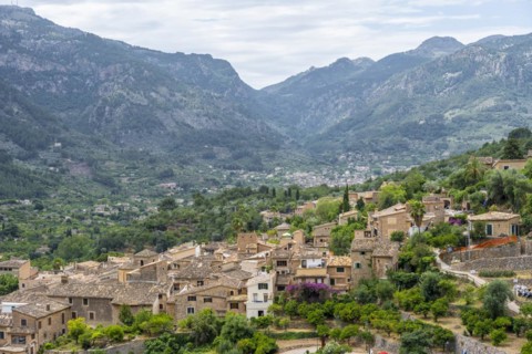 View over typical houses of the mountain village Fornalutx with mountain landscape