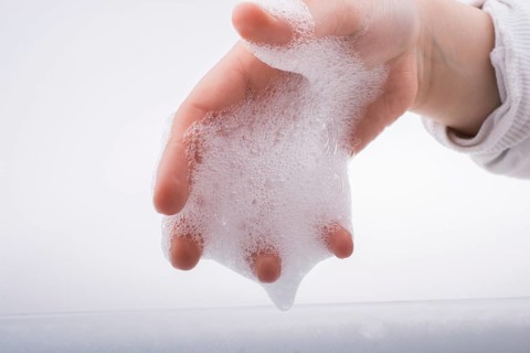 Hand washing and soap foam on a foamy background
