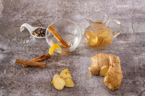 Jar of fresh ginger tea with lemon and cinnamon