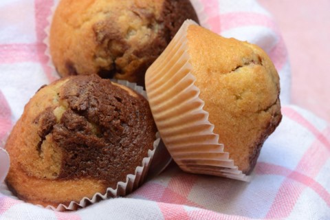 Chocolate muffins in kitchen towel