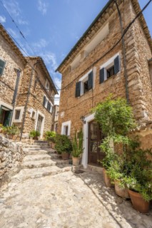 Flower pots in an alley with typical stone houses