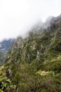 Steep cloudy mountain landscape with rock formations