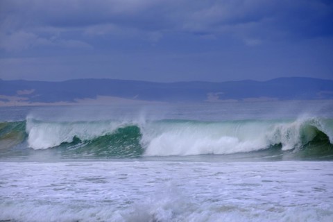Waves on the beach with dark sky