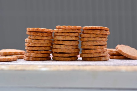 Home baked selfmade dog treat cookies stacked in a row